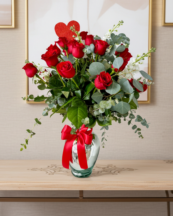 Celebrate LOVE with 25 beautiful roses, stocks, and mixed foliage, arranged in a silver or gold glass base and ribbon. A perfect gift to make hearts bloom on Valentine’s Day or any special occasion!
Gladys Flowers Miami