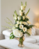 A sympathy floral arrangement featuring white roses, hydrangeas, and gerberas in a clear vase by Gladys Flowers in Kendall, Miami.